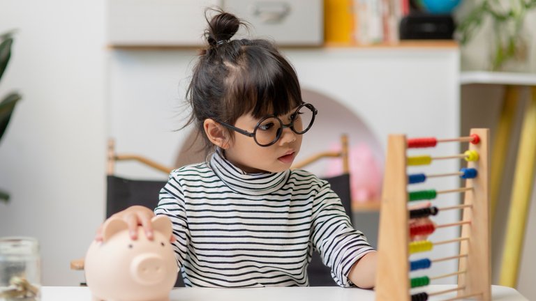 little girl playing with child like finance toys