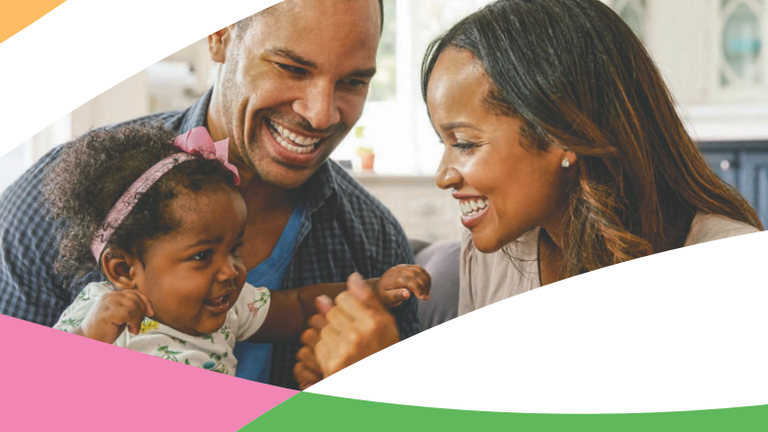 Family smiling and laughing with their daughter